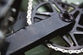 Close-up in shallow depth of field. Mountain bike pedals with large gear and chain. Cycling concept background Royalty Free Stock Photo