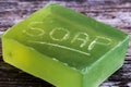 Close-up, shallow focus of a bar of natural soap with engraved letters on its side. Royalty Free Stock Photo