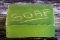 Close-up, shallow focus of a bar of natural soap with engraved letters on its side. Royalty Free Stock Photo