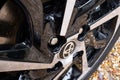 Close-up, shallow focus of a Japanese auto logo seen on an alloy wheel.