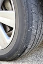 Close-up shallow focus shot of an old worn-out tire with cracks. Seems to be dangerous for drivers and passengers. It should be