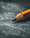 Close-up of a sharp pencil tip on textured gray background, emphasizing detail and precision Royalty Free Stock Photo