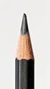 Close-up of a sharpened black pencil on white background, minimalistic stationery concept