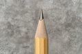 Close-up of a sharpened pencil against a textured background.