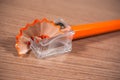 Close up of sharpener and orange pencil Royalty Free Stock Photo