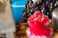 Close up the shave ice with red sugar syrup, topping with sweetened condensed milk Royalty Free Stock Photo