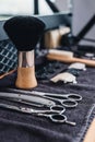 Close-up shaving brush, razor, scissors, combs on the table on a black towel. Professional barber tools and equipment. Barbershop Royalty Free Stock Photo