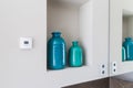 Close-up shelf detail of a bathroom with 2 green and blue vases. Royalty Free Stock Photo