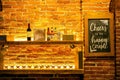 Close-up of a shelf of various types of alcoholic beverage bottles illuminated with light in a bar Royalty Free Stock Photo
