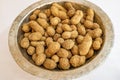 Shelled peanuts in metal bowl Royalty Free Stock Photo