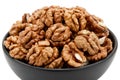 Close-up of shelled walnuts in a bowl isolated on white background, angled view. Royalty Free Stock Photo