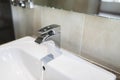 A close up of a shiny chrome modern tap in the bathroom of a luxury hotel Royalty Free Stock Photo