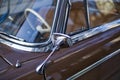 Close up of shiny chrome rear view mirror of classic car