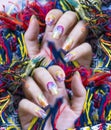 Close up shiny Colorful gel polish painting cute galaxy nail art on beautiful woman fingernail
