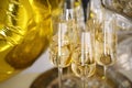 Close up of shiny glasses of champagne over party background Royalty Free Stock Photo