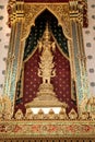 Close up shiny golden buddhist statue on exterior wall of buddhist temple,Wat Arun in Bangkok, Thailand