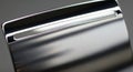A close-up of a shiny, metallic surface with a sleek, brushed texture. The object features Royalty Free Stock Photo