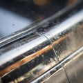 Close-up of a shiny metallic surface with a smooth, curved shape. The surface Royalty Free Stock Photo