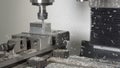 CLOSE UP: Shiny shavings fly off a piece of aluminium being processed by a drill