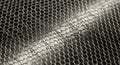 Close-up of a shiny silver metal hexagonal mesh grid abstract texture background Royalty Free Stock Photo