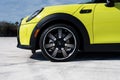 Close up of shiny wheel of Mini Cooper S Cabriolet parker on solid asphalt outside. Tire of British brand vehicle with