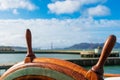 Close up. Ship steering wheel with blurred pier in San Francisco Bay