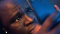 Close up Shocked african american black man reading email wrapped in blanket. Bad news Royalty Free Stock Photo