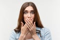 Close up Shocked girl covering mouth with hands. Keep silence concept. Studio shot white background Royalty Free Stock Photo