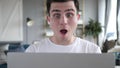 Close Up of Shocked Man Wondering and Working on Laptop Royalty Free Stock Photo