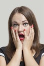 Close-up of shocked young woman with gray eyes and red lips Royalty Free Stock Photo