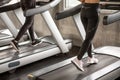 Close up shoe group of young  people walking on treadmills warm up in sport gym  . two fitness woman runner on running machine in Royalty Free Stock Photo