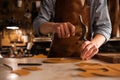 Close up of a shoemaker man working with leather