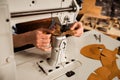 Close up of a shoemaker using sewing machine