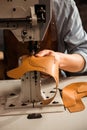 Close up of a shoemaker using sewing machine