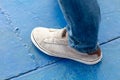Close-up of shoes on a man& x27;s feet on a blue floor