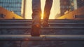 Close-up on the shoes of a professional ascending steps against the sunset backdrop in a bustling city environment.