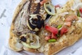 Close-up shoot of fish and bread food with tomato, onion, pepper on the street Royalty Free Stock Photo