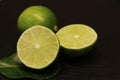 Close up shoot of green fresh lime on a black background Royalty Free Stock Photo