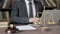 Close up Shoot of Judge Hand using Laptop and Notes in Court Room Royalty Free Stock Photo