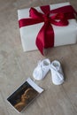 Little baby shoes ultrasound snapshoot gift box, long-awaited pregnancy concept