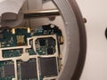 Close up shoot of printed circuit board PCB sitting on a white repair stand with magnifier for better examining small parts