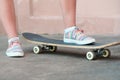 Close up shoot of sneakers on skateboard in casual style in summer day on the street