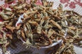 Close-up shoot of traditionally dried under sun string beans on small cup with spreaded vegetables. Royalty Free Stock Photo