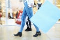 Close Up Of Shoppers Feet Carrying Bags In Shopping Mall Royalty Free Stock Photo