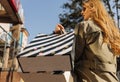 Close-up of shopping bags and woman`s developing hair. women hold shopping bags on the street Royalty Free Stock Photo