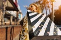 Close-up of shopping bags and woman`s developing hair. women hold shopping bags on the street Royalty Free Stock Photo