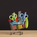 Close up of shopping cart with school stationery for sale Royalty Free Stock Photo