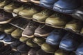 Close up of shopping stand with budget-freindly unisex shoes for autumn and spring. Shelves with men's sport shoes in shoe market Royalty Free Stock Photo