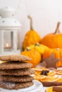 Close-up of shortbread cookies with orange slices, cinnamon, candle and pumpkins, selective focus, white background Royalty Free Stock Photo