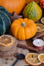 Close-up of shortbread cookies with orange slices, cinnamon and candle on wooden table with pumpkins, selective focus, Royalty Free Stock Photo